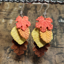 Load image into Gallery viewer, Two dangle earrings with fall leaves cascading down as if stacked on top of each other. A red maple leaf is on top, followed by an orange beech, and yellow aspen, and a brown oak.