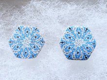 Load image into Gallery viewer, A close up picture of two hexagon shaped earrings with intricate white, silver and blue patterns. 
