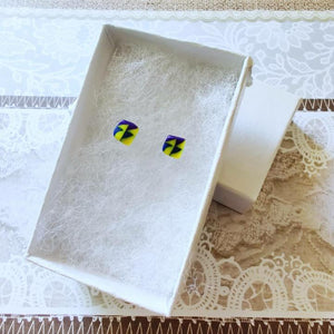White paper jewelry box with square earrings made of triangle design using yellow, blue, and purple