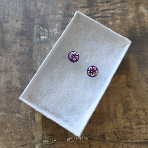 White and gold flowers on a purple background stud earrings in a white paper jewelry box