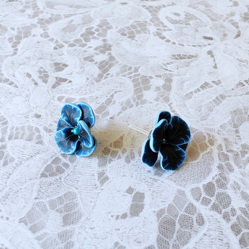Blue and black flower shaped earrings with blue metallic centers