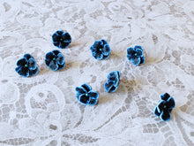 Load image into Gallery viewer, Four pairs of blue and black flower shaped earrings with blue metallic centers
