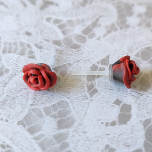 A pair of red and black rose flower earrings