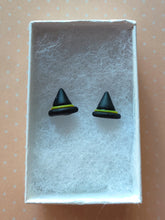 Load image into Gallery viewer, A pair of black witches hats with yellow bands made into flat backed stud earrings. Earrings are displayed in a white paper jewelry box. 
