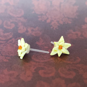 A close up of a pair of white Poinsettia earrings.