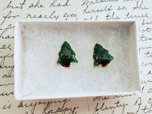 Load image into Gallery viewer, A pair of earrings made to look like sugar cookies decorated like a green Christmas tree with red sugar pearls as ornaments. The earrings are inside a white paper jewelry box.
