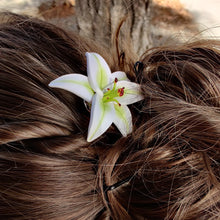 Load image into Gallery viewer, Side view of a medium lily pin in a bun hair style. 
