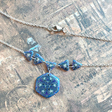Load image into Gallery viewer, A close up view of the necklace showing small glitter details. 
